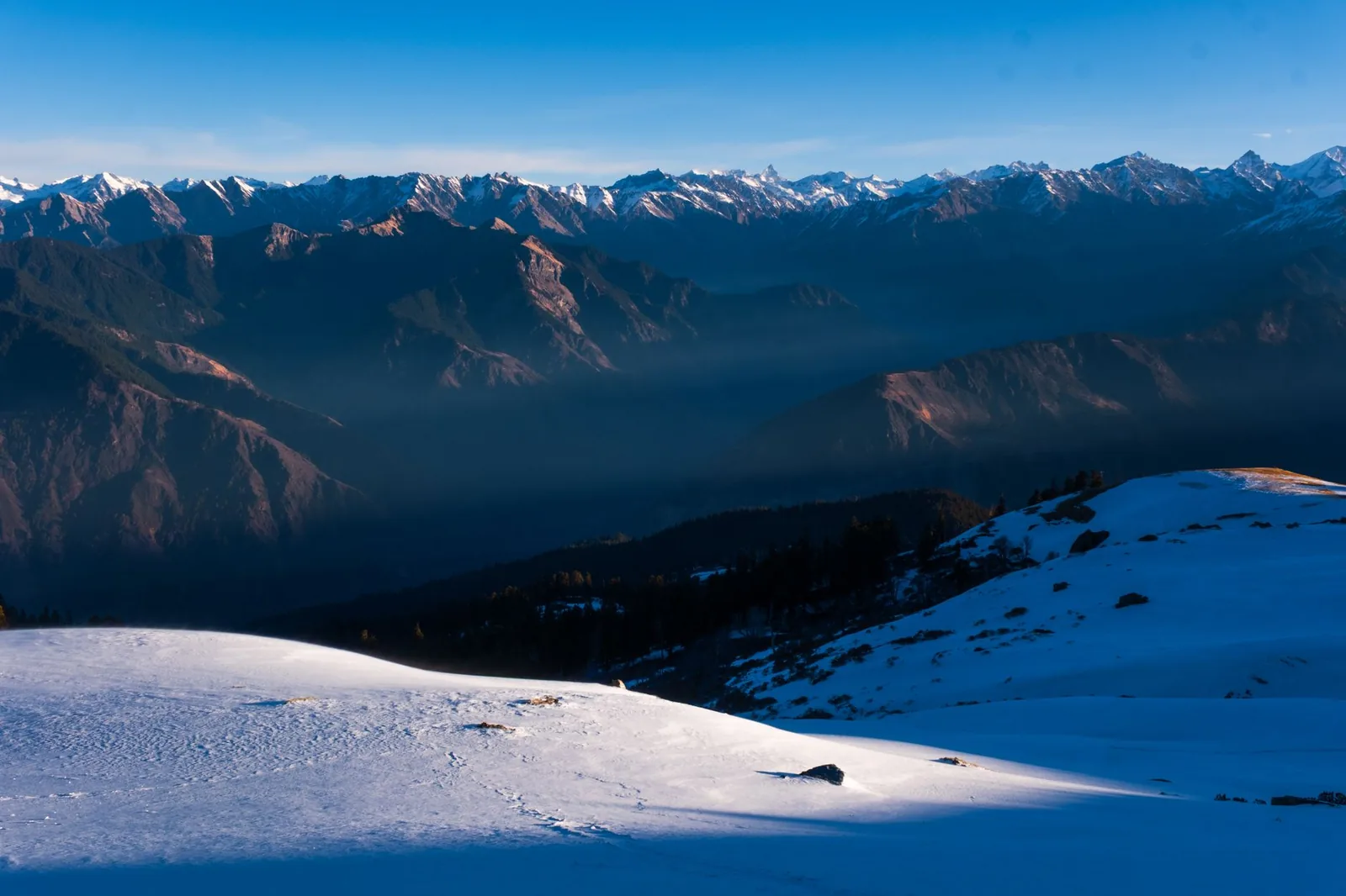 Trekkers on a high Himalayan ridge at sunrise in Uttarakhand