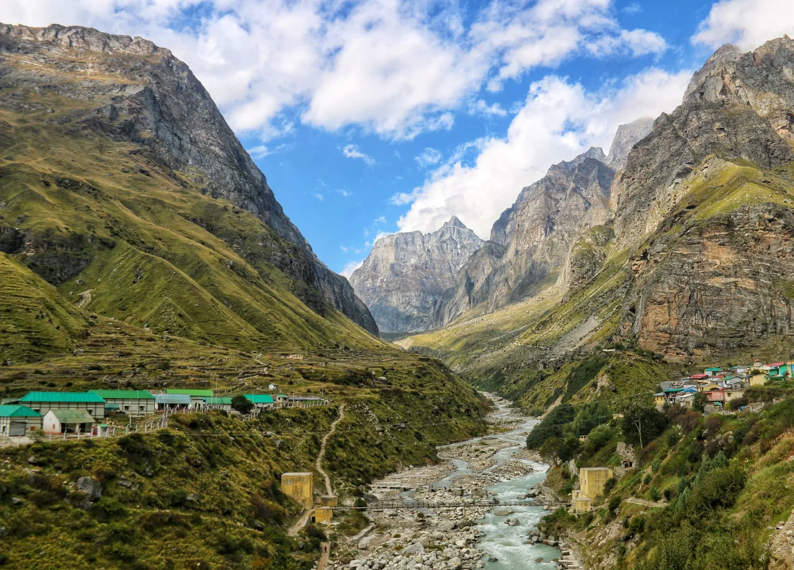 Green Himalayan valley ringed by snow peaks in Uttarakhand