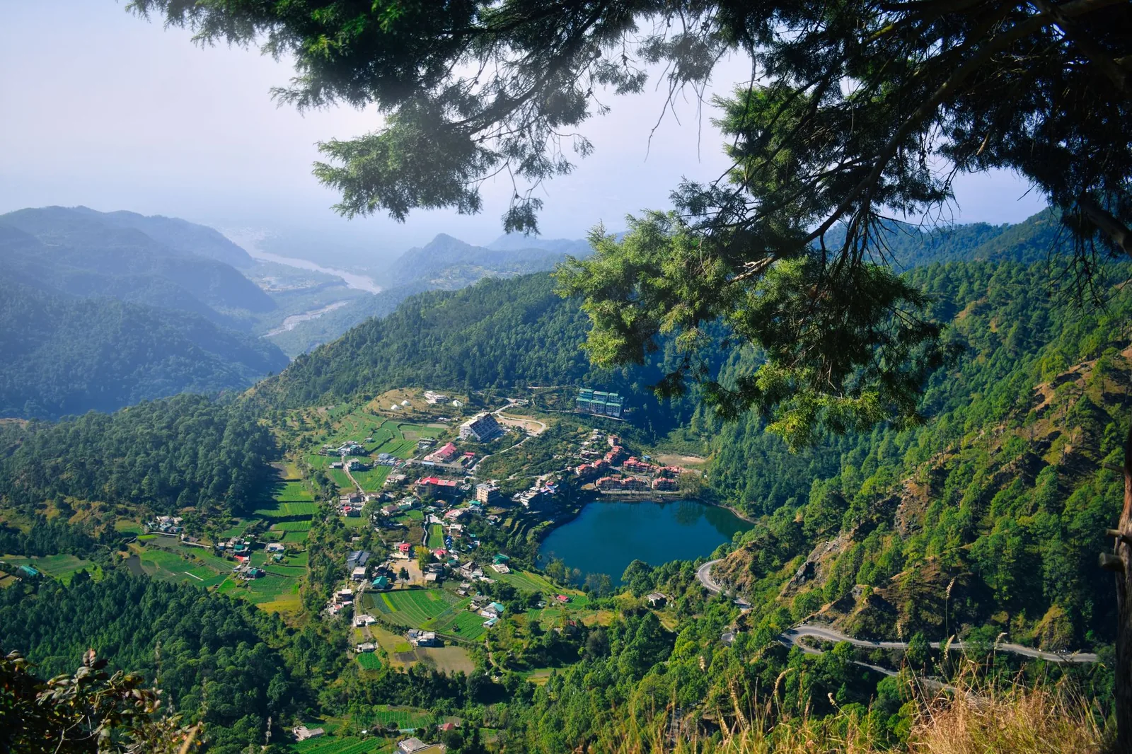 Himalayan hill-station town beside a lake with mountain views